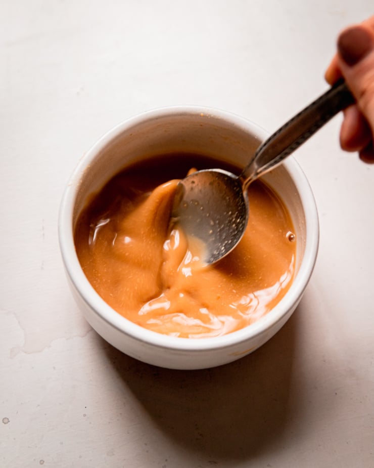 An overhead shot shows hot water and miso being stirred together in a small bowl.