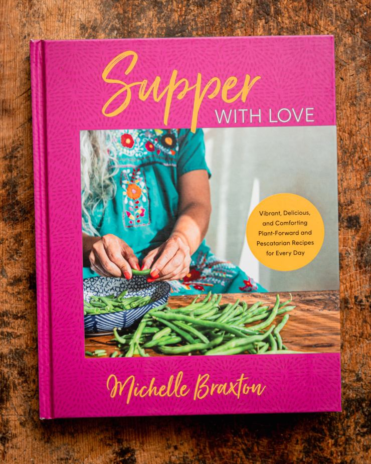 An overhead shot shows the cookbook "Supper with Love" by Michelle Braxton