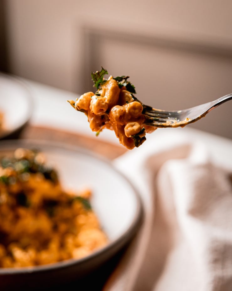 A head-on image shows a forkful of vegan truffle mac.