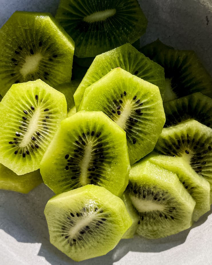 Am up close overhead shot shows kiwi slices in the sun.