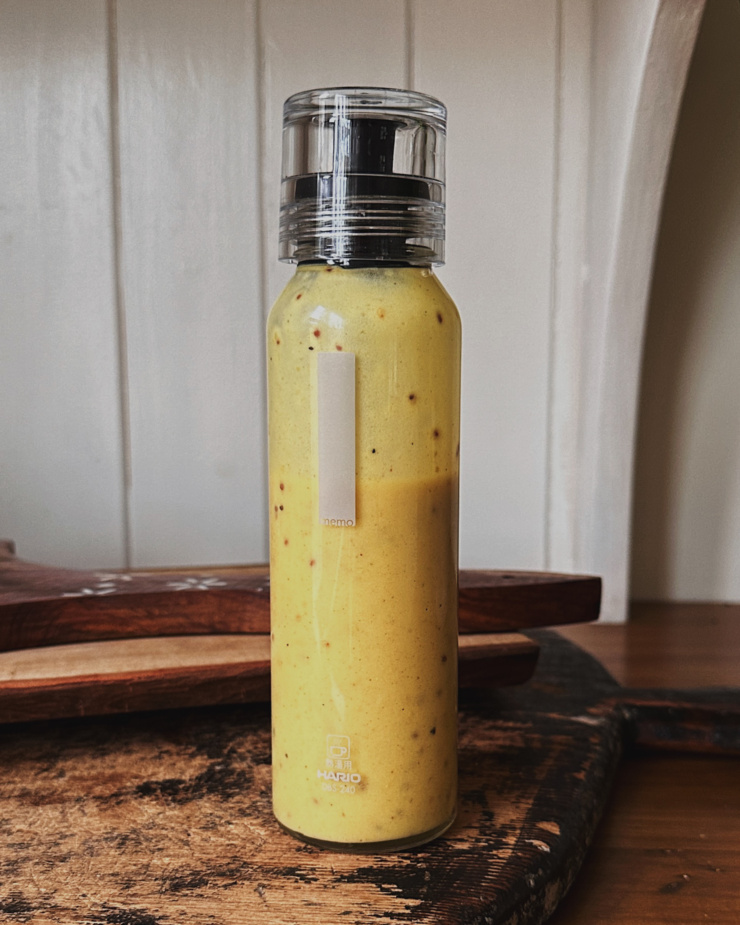A head-on shot shows a bottle of sweet mustard dressing.