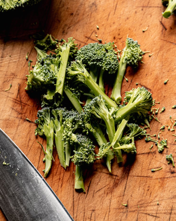 An overhead shot shows broccoli florets that have been finely cut.