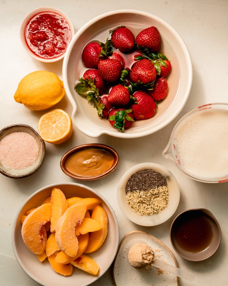 An overhead shot shows ingredients for a strawberry lemonade smoothie.