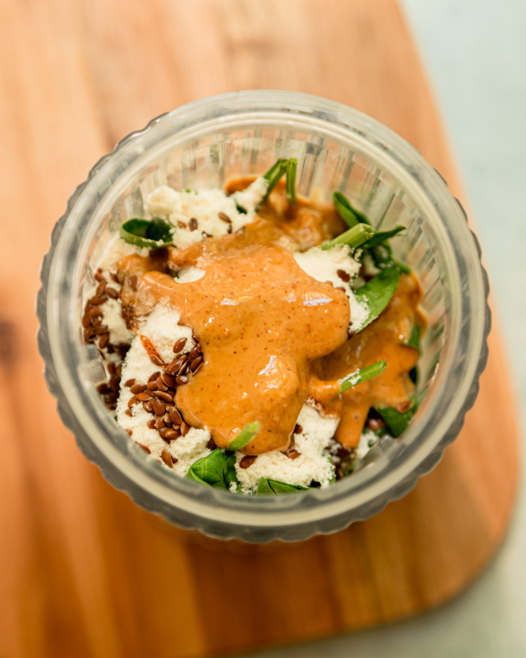 An overhead shot shows ingredients in a blender container.