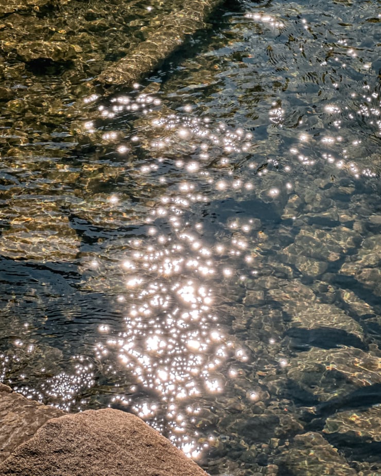 An overhead shot shows sparkling clear water in a creek.