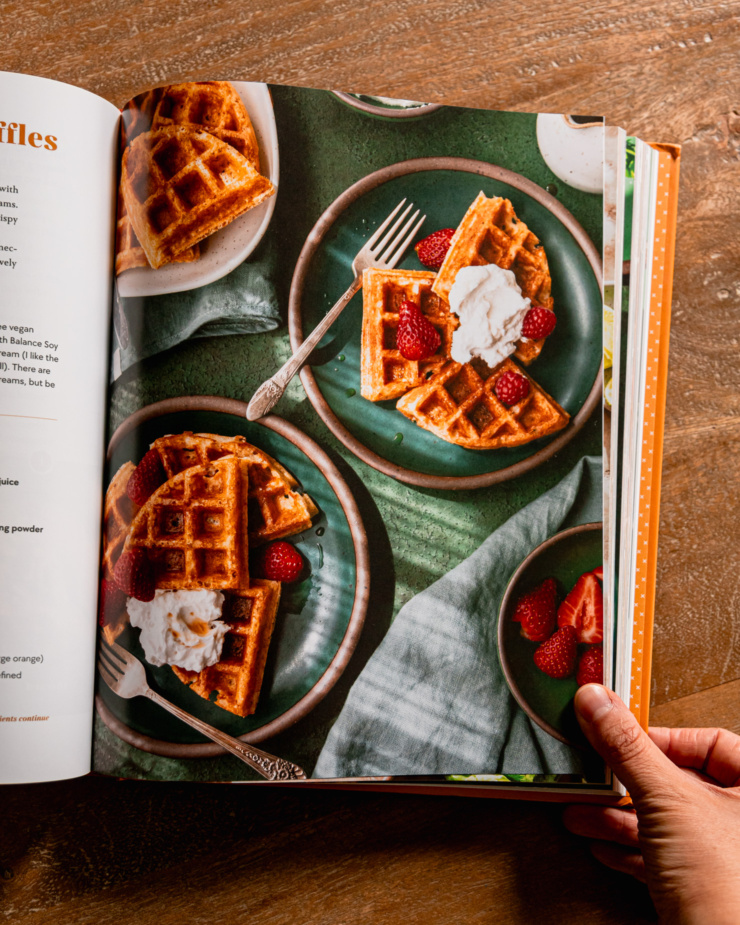An overhead shot shows a page open on the cookbook "Big Vegan Flavor"