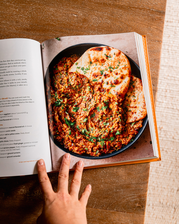 An overhead shot shows a page open on the cookbook "Big Vegan Flavor"