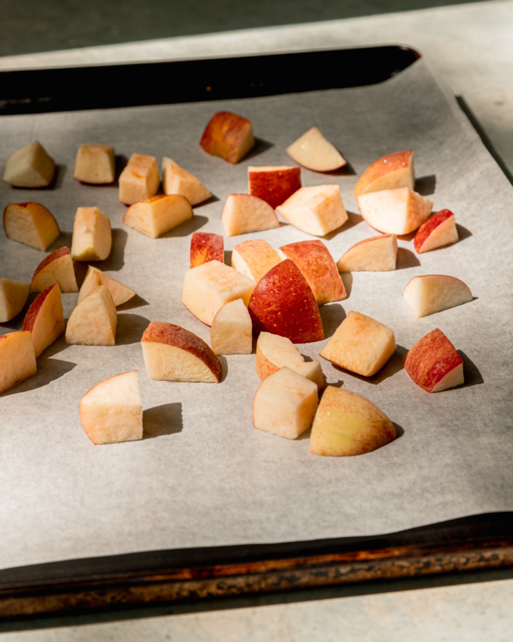 A 3/4 angle image shows frozen apple chunks on a baking sheet.