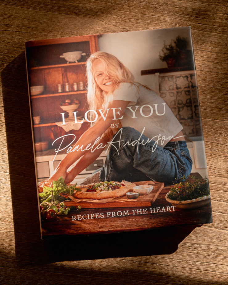 An overhead shot shows Pamela Anderson's "I Love You" cookbook.