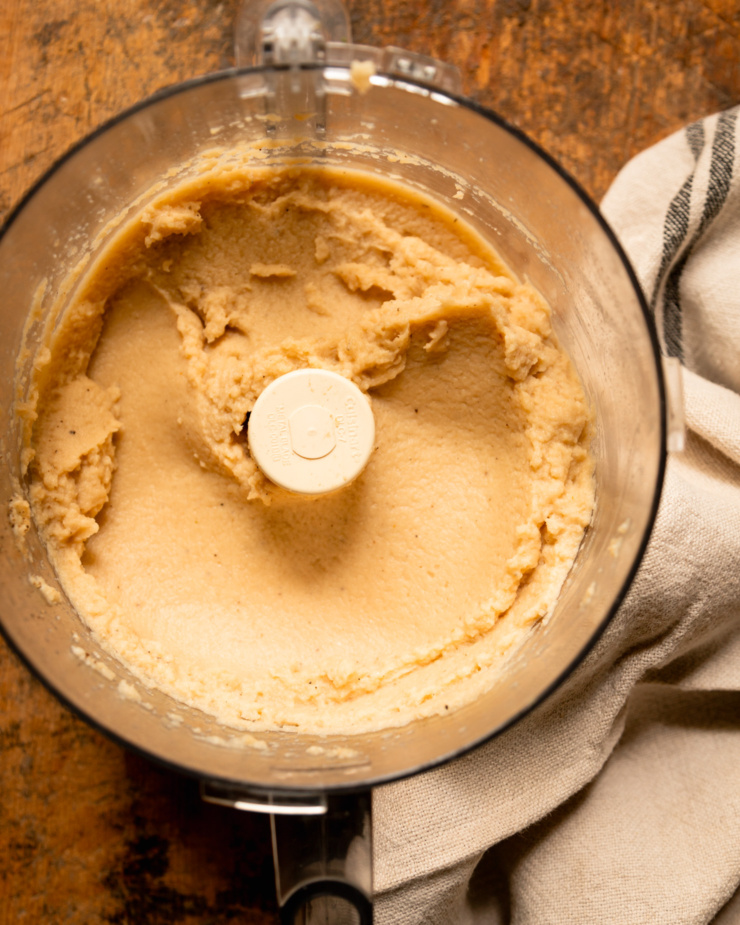 An overhead shot shows cooked cauliflower that's been whipped up in a food processor.