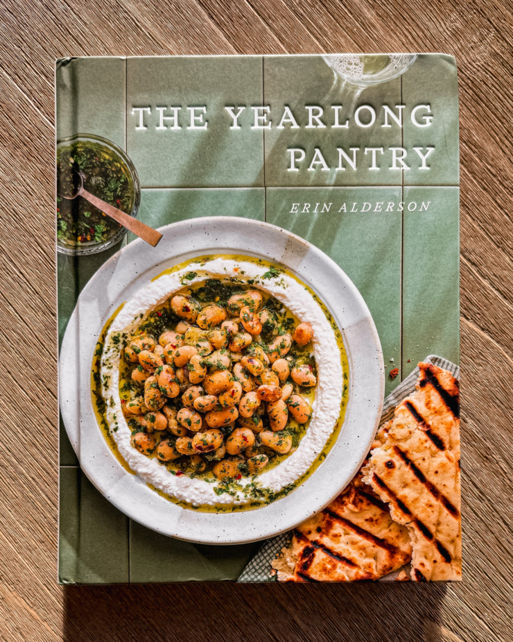 An overhead shot shows "The Yearlong Pantry" cookbook by Erin Alderson.