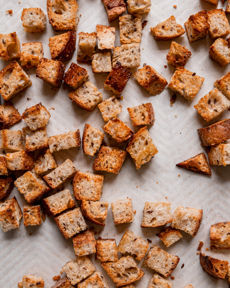 An overhead shot shows toasted multigrain bread cubes.