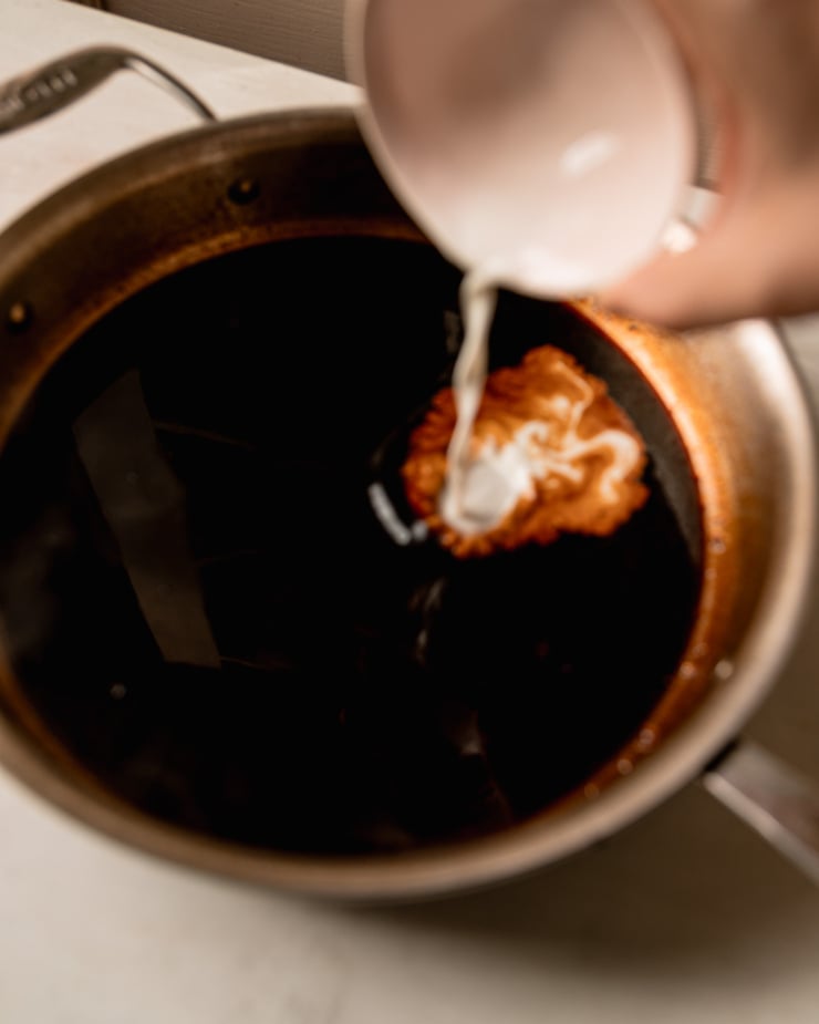 A 3/4 angle image shows a cornstarch slurry being added to a skillet of homemade teriyaki sauce.