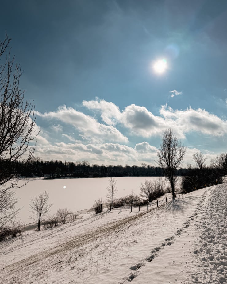 A head on shot shows a wintery scene on a bright sunny day.