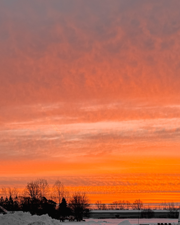 A head-on shot shows a beautiful sunrise with shades of pink and orange.
