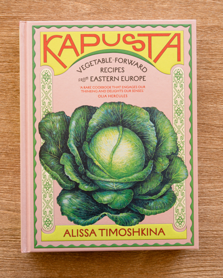 An overhead shot shows the cover of the cookbook "Kapusta"