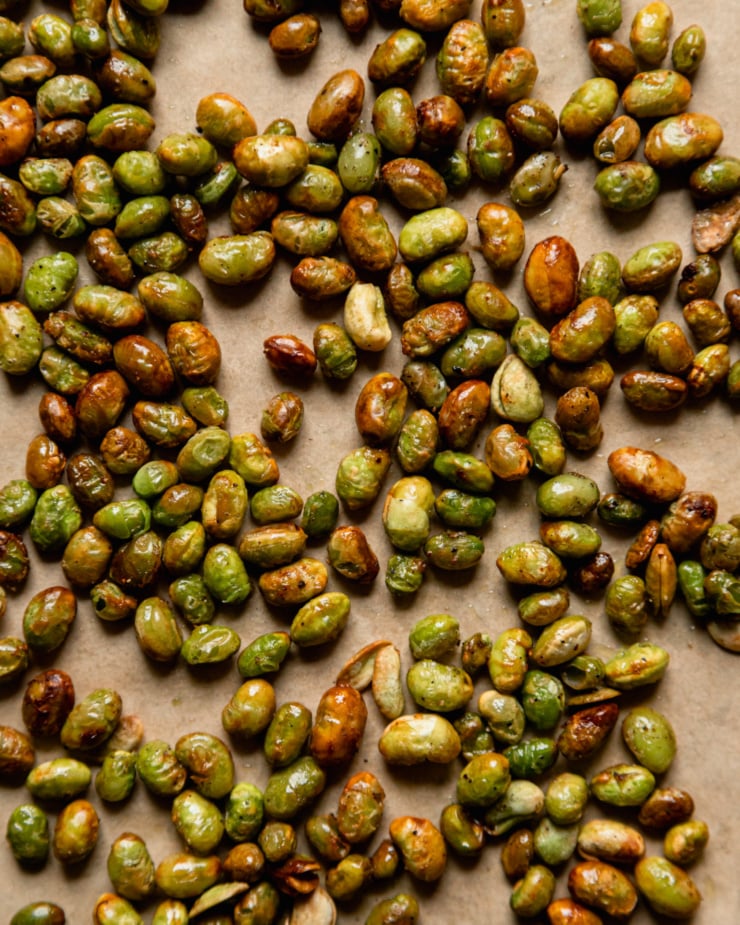 An up close, overhead shot shows crispy edamame made int he air fryer. They are golden brown on the edges.