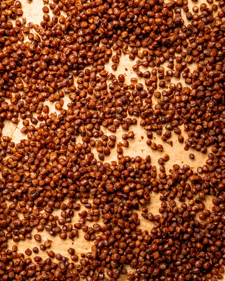 An overhead shot shows smoky roasted brown lentils on parchment paper.