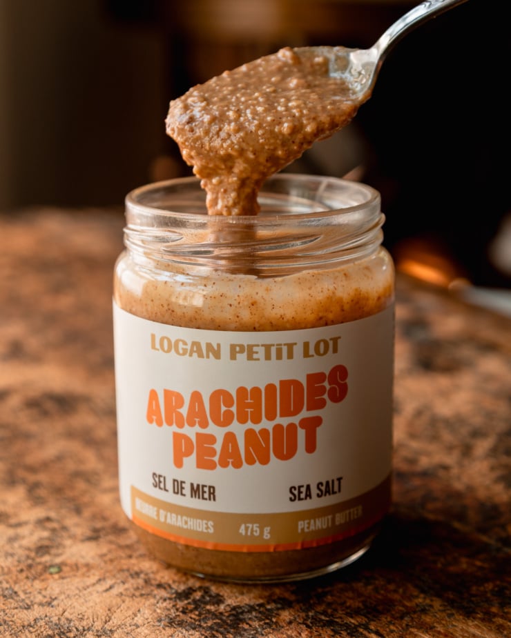 A head-on shot shows a jar of peanut butter with a spoonful lifting out of the jar.