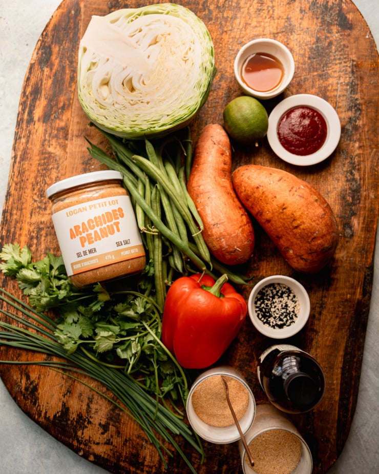 An overhead shot shows ingredients for a roasted sweet potato salad with spicy peanut dressing.