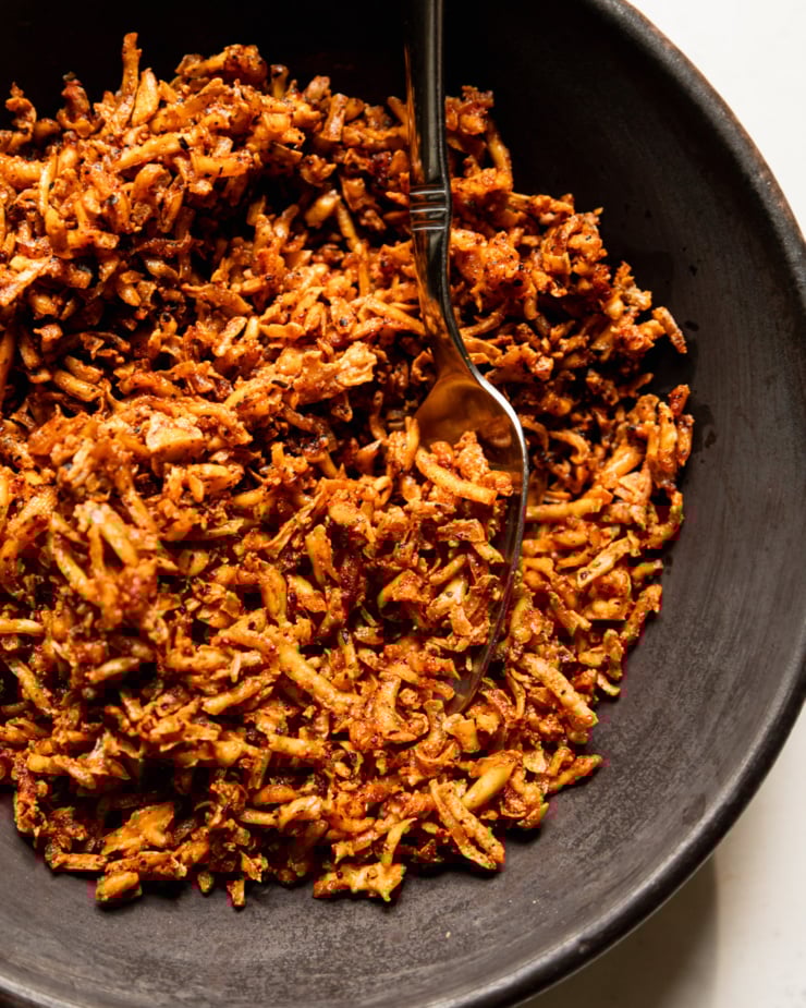 An overhead shot shows a bowl filled with crispy and chewy baked tofu shreds.