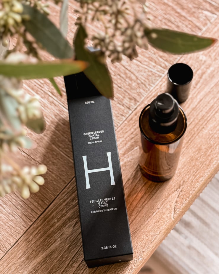 An overhead shot shows a bottle of Health Hut's room spray and its packaging nearby.