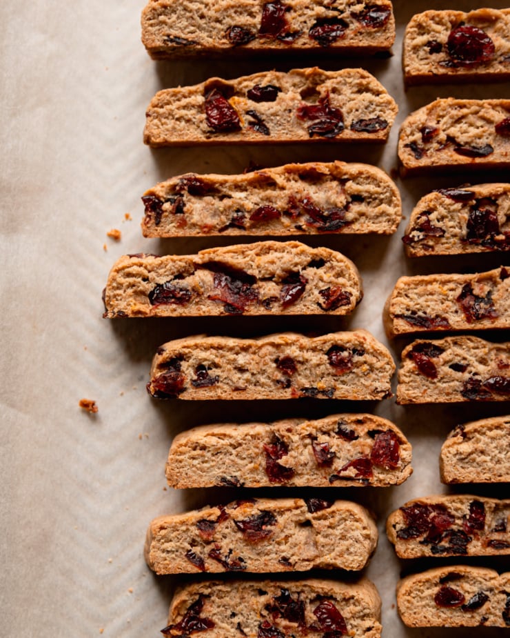 An overhead shot shows vegan orange cranberry biscotti after their second bake.