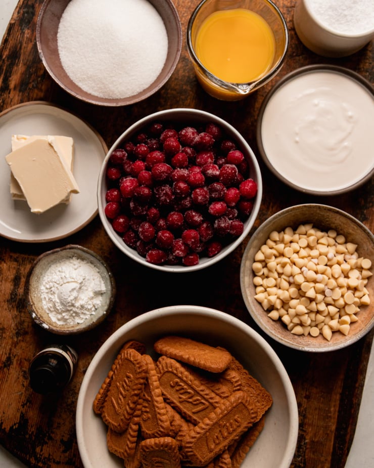 An overhead shot shows ingredients needed for a vegan cranberry tart with white chocolate and Biscoff crust.
