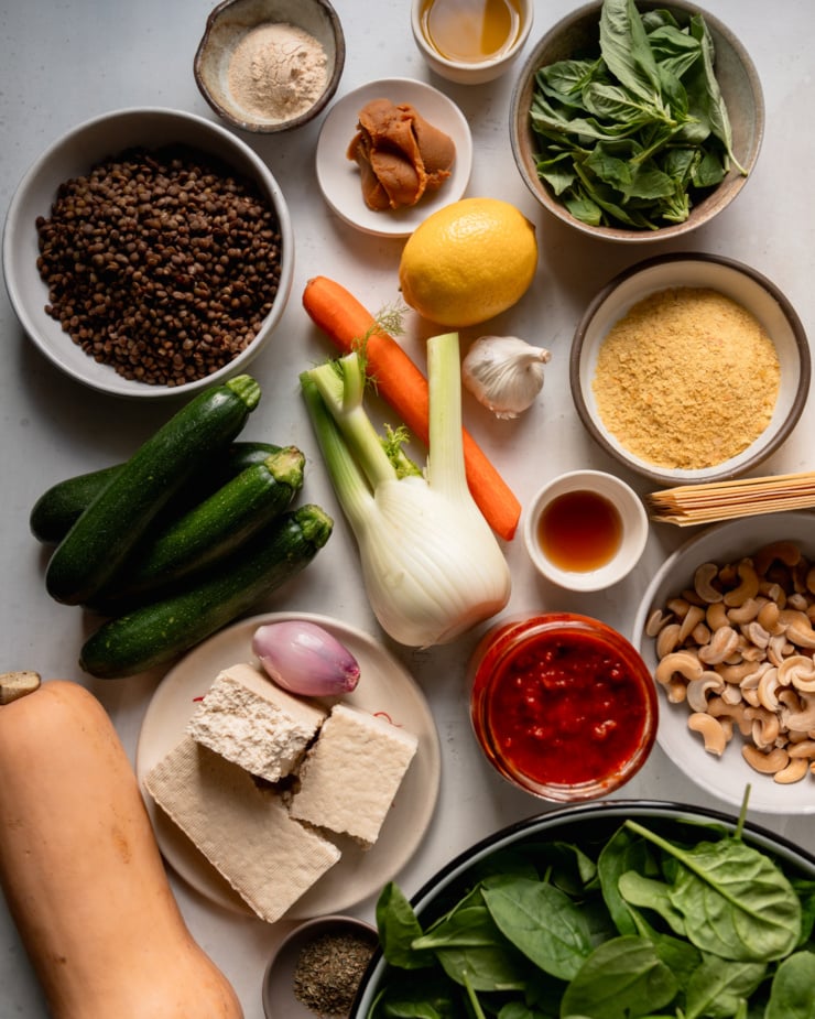 An overhead shot shows ingredients for a vegan lasagna recipe.