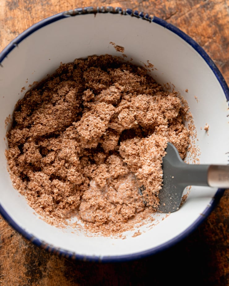 An overhead shot shows wheat bran being combined with a vegan "buttermilk" mixture in a bowl.
